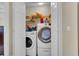 Laundry closet with a front loading washer and dryer and storage space for detergent and supplies at 9360 S Moreto Cir, Summerville, SC 29485