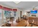 View of a comfortable living room with large windows and a cat tree, perfect for pet lovers at 9360 S Moreto Cir, Summerville, SC 29485