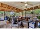 Comfortable screened patio with ample seating, ceiling fans, and a view of the outdoor landscape at 9360 S Moreto Cir, Summerville, SC 29485