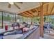 Cozy screened-in patio with wicker furniture, ceiling fans, and a view of the private backyard at 9360 S Moreto Cir, Summerville, SC 29485