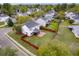 Well-manicured lawn and fenced-in backyard complement this home, complete with a brick patio at 9400 Divot Ln, Summerville, SC 29485