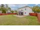 View of backyard showcasing home, brick patio, screened-in porch and privacy fence at 9400 Divot Ln, Summerville, SC 29485