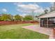 Spacious backyard featuring lush green grass, privacy fence, brick patio and access to screened-in porch at 9400 Divot Ln, Summerville, SC 29485