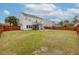 Expansive backyard with mature trees, a privacy fence, and a patio and screened in back porch at 9400 Divot Ln, Summerville, SC 29485