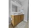 Well-lit bathroom with double sink vanity, featuring a rug and ample counter space at 9400 Divot Ln, Summerville, SC 29485