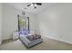 Bright bedroom with a ceiling fan, large window, and two nightstands creating a cozy and inviting space at 9400 Divot Ln, Summerville, SC 29485