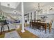 Open-concept dining area with wood floors, large table, and seamless transition to the living room at 9400 Divot Ln, Summerville, SC 29485