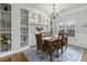 Formal dining room featuring a wooden table, decorative chandelier, and built-in shelving at 9400 Divot Ln, Summerville, SC 29485
