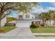 Charming two-story home featuring a manicured lawn, palm trees and an attached two-car garage at 9400 Divot Ln, Summerville, SC 29485