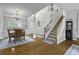 Inviting foyer with wood floors, adjacent dining room and a staircase leading to the upper level at 9400 Divot Ln, Summerville, SC 29485