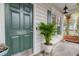 Attractive front door displaying house number with sidelight window, potted plants and lantern-style porch light at 9400 Divot Ln, Summerville, SC 29485