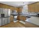 Kitchen with stainless steel appliances, wood cabinets, tile backsplash, and hardwood floors at 9400 Divot Ln, Summerville, SC 29485