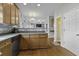 A well-lit kitchen featuring wooden cabinets, modern appliances, and an open design to the living area at 9400 Divot Ln, Summerville, SC 29485