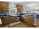 Kitchen features stainless appliances, tile backsplash, wood cabinets, and hardwood floors at 9400 Divot Ln, Summerville, SC 29485