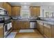 Kitchen with stainless steel appliances, wood cabinets, tile backsplash, and hardwood floors at 9400 Divot Ln, Summerville, SC 29485