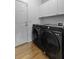 Modern laundry room showcasing front load washer and dryer and white cabinets at 9400 Divot Ln, Summerville, SC 29485