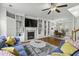 Living room with hardwood floors, fireplace, custom built-ins, and an open layout flowing into the dining area at 9400 Divot Ln, Summerville, SC 29485