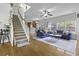 Inviting living room featuring hardwood floors, ceiling fan, and an abundance of natural light at 9400 Divot Ln, Summerville, SC 29485