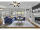 Bright living room featuring hardwood floors, large windows, and a cozy fireplace with built-in shelving at 9400 Divot Ln, Summerville, SC 29485