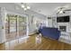 Bright living room with access to screened porch, fireplace, custom built-ins, and large windows at 9400 Divot Ln, Summerville, SC 29485