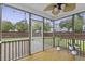 Relaxing screened-in porch with ceiling fan, tile floor, and backyard view perfect for enjoying the outdoors at 9400 Divot Ln, Summerville, SC 29485