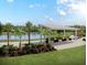 Enjoy a relaxing outdoor space with a pergola, benches, and lush landscaping near the lake at 945 Dusk Dr, Summerville, SC 29486