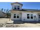 New construction home exterior featuring visible Tyvek wrap, windows, and concrete porch at 947 Dusk Dr, Summerville, SC 29486