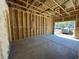 New construction garage with concrete floor, wood framing, and an open garage door at 947 Dusk Dr, Summerville, SC 29486