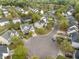 Breathtaking aerial view of a tranquil neighborhood featuring beautiful homes surrounding a serene lake at 9684 Pebble Creek Blvd, Summerville, SC 29485