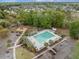 Overhead shot of the community pool with playground, parking, lounge chairs, and a nearby neighborhood at 9684 Pebble Creek Blvd, Summerville, SC 29485