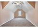 Finished attic space with carpet, natural light, and vaulted ceiling, offering a versatile room at 9684 Pebble Creek Blvd, Summerville, SC 29485