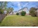 Lush backyard featuring a green lawn, mature trees, and a privacy fence at 9684 Pebble Creek Blvd, Summerville, SC 29485