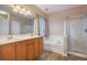 Well-lit bathroom featuring a double vanity, separate tub, and shower, offering comfort and style at 9684 Pebble Creek Blvd, Summerville, SC 29485