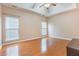 Spacious bedroom features tray ceiling, ceiling fan, hardwood floors, and natural light from two windows at 9684 Pebble Creek Blvd, Summerville, SC 29485