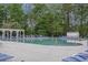 Community pool with lounge chairs, landscaped grounds, and an adjacent pergola at 9684 Pebble Creek Blvd, Summerville, SC 29485