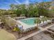 Aerial view of community pool with lounge chairs, landscaped grounds, and an adjacent pergola at 9684 Pebble Creek Blvd, Summerville, SC 29485