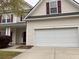 Two-story home featuring a two-car garage, red shutters, and light-colored siding at 9684 Pebble Creek Blvd, Summerville, SC 29485