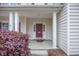 Welcoming front entrance featuring a covered porch, elegant columns, and beautiful landscaping at 9684 Pebble Creek Blvd, Summerville, SC 29485