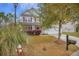 Inviting two-story house featuring a well-kept lawn, beautiful landscaping, and a cozy front porch at 9684 Pebble Creek Blvd, Summerville, SC 29485