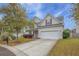 Charming two-story home with a two-car garage, well-manicured lawn, and inviting curb appeal at 9684 Pebble Creek Blvd, Summerville, SC 29485