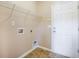 Neutral laundry room featuring shelving, a white door, and tile flooring, ready for appliances at 9684 Pebble Creek Blvd, Summerville, SC 29485