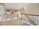 Inviting carpeted loft area with wooden railings, providing an open space for relaxation or entertainment at 9684 Pebble Creek Blvd, Summerville, SC 29485