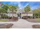 Charming pool house entrance with palm trees, well-manicured landscaping, and accessible walkway at 9684 Pebble Creek Blvd, Summerville, SC 29485