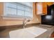 Close up of a stainless steel kitchen sink with a modern faucet and neutral countertops at 9684 Pebble Creek Blvd, Summerville, SC 29485