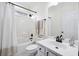 Bathroom featuring a white tub with shower, toilet, and vanity with black fixtures at 102 Kapalua Run, Summerville, SC 29483