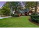 Charming brick home featuring a well-manicured lawn, mature trees, and an inviting entrance at 102 Kapalua Run, Summerville, SC 29483
