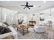 Bright living room with vaulted ceiling, wood floors, and open floor plan to kitchen and dining area at 102 Kapalua Run, Summerville, SC 29483
