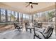 Relaxing screened porch featuring comfortable outdoor seating and view of trees at 102 Kapalua Run, Summerville, SC 29483