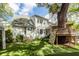 Landscaped backyard featuring a climbing wall, slide, custom treehouse, and manicured lawn at 1021 Barfield St, Charleston, SC 29492
