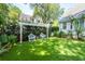 Entertain on this manicured lawn, featuring pergola, white fencing, and seating at 1021 Barfield St, Charleston, SC 29492